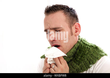 Der Mensch leidet unter Allergien oder die Grippe. Er bläst seine Nase, wenn er niest Stockfoto