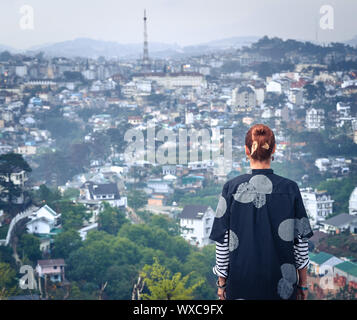 Frau mit Blick auf die Stadt, Dalat, Vietnam Stockfoto