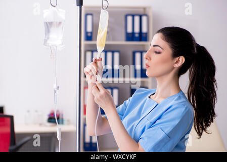 Junge Ärztin in der Infusion Konzept Stockfoto