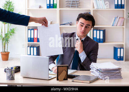 Junge männliche Mitarbeiter, von seiner Arbeit entlassen Stockfoto