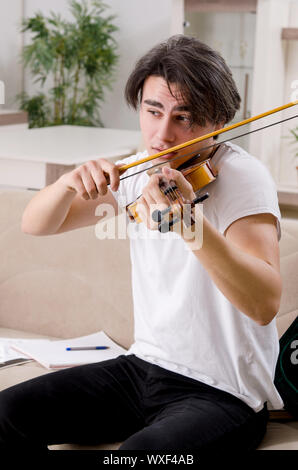 Junge Musiker Mann spielen Geige Üben zu Hause Stockfoto