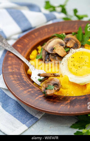 Köstliche Polenta mit Pilzen und Ei. Stockfoto