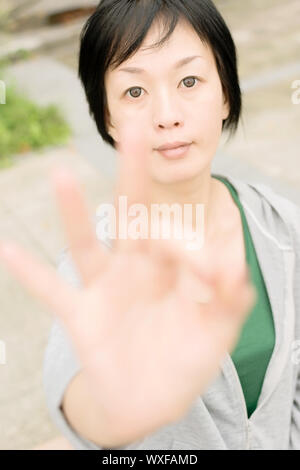 Sport reifen Frau geben Sie eine Geste Zeichen, Nahaufnahme portrait in outdoor Park in der Stadt. Stockfoto