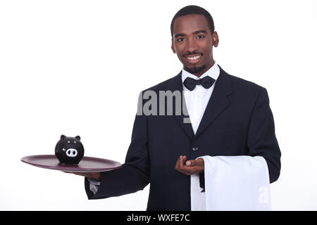 Kellner mit Sparschwein Stockfoto