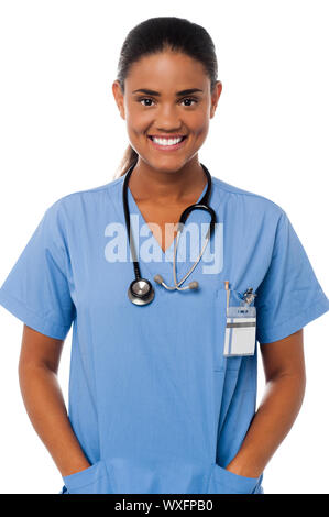 Halbe Länge Bild von einer Ärztin in Uniform mit den Händen in der Tasche posing Stockfoto