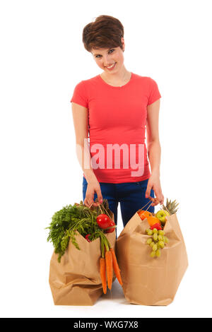 Hübsche junge Frau mit schweren Taschen gesundes Gemüse und Obst isoliert auf weißem Hintergrund Stockfoto