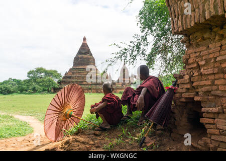 Buddhistische Mönche Ruhe und einen alten Tempel im Old Bagan, Myanmar bewundern. Stockfoto