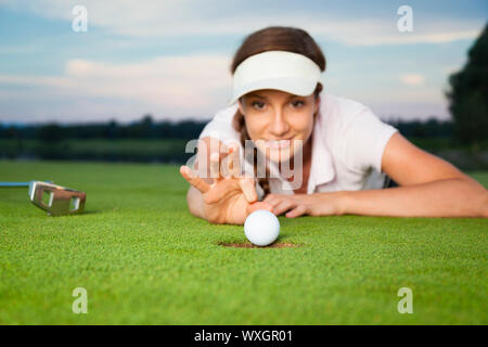 Mädchen Golfspieler einen Trick auf Grün. Stockfoto