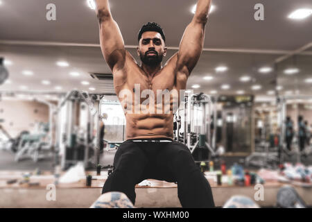 Mann Sportler tun Pull Ups - Klimmzüge In der Turnhalle Stockfoto