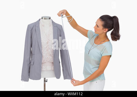 Mode-Designer Blazer Ärmel an Puppe auf weißem Hintergrund zu messen Stockfoto