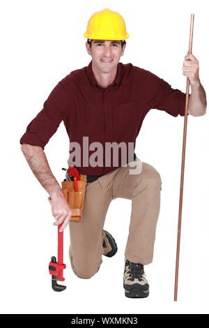Porträt der schönen Klempner mit verstellbaren Schraubenschlüssel und Rohr Stockfoto