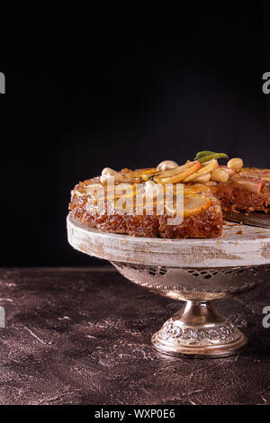 Französische süße pie Tarte tatin Apfelkuchen verkehrt herum auf grauem Beton Hintergrund. Stockfoto