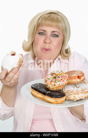 Frau Essen Donuts Stockfoto