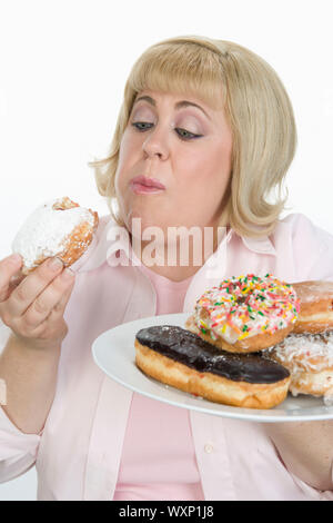 Frau Essen Donuts Stockfoto