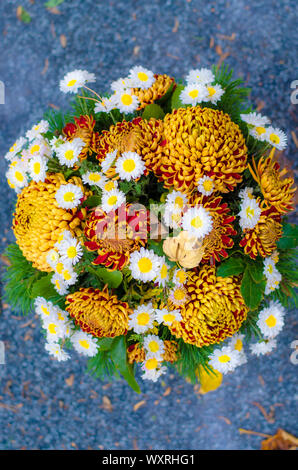 Blumenstrauß aus bunten Blumen während christliche Allerheiligen Veranstaltung im Grab auf dem Friedhof liegen Stockfoto