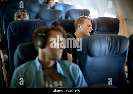 Männer schlafend auf dem Flugzeug Stockfoto