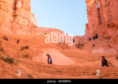 Bryce Canyon City, UT / 09-27-2016: Menschen Wanderung in den Canyon, umgeben von hohen Mauern, die aus Sandstein sind die Grundlage der HOODOOS in Schluchten gefunden bei Bry Stockfoto