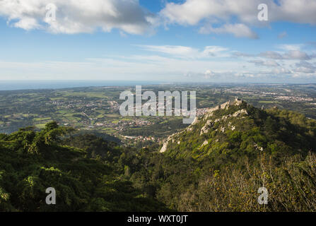 Blick auf die mittelalterliche Burg der Mauren (Castelo dos Mouros) und die umliegende grüne Landschaft vom Pena Palast, Sintra, Portugal. Stockfoto