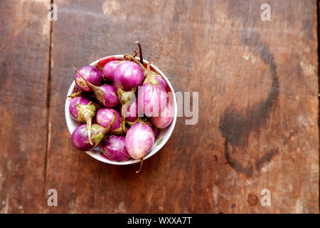 Frische thailändische Auberginen in eine Schale auf einem Holz- Oberfläche. Fokus Wählen. Stockfoto