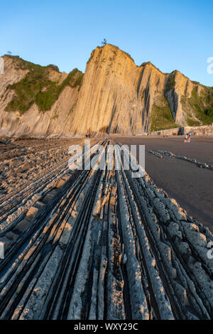 Flysch, itzurun Strand, eine Sequenz von Sedimentgestein Schichten, bei Sonnenuntergang, Zumaia, Baskenland, Spanien Stockfoto