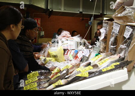 Markt HÄNDLER IN EINEM FISCHMARKT IN DER WESTLICHEN WELT. Moderne am frühen Morgen HÄNDLER IN BILLINGSGATE FISH MARKET IN LONDON, England, UK. Meeresfrüchte von produzieren, Schottland, Wales, Irland, England, DER EUROPÄISCHEN UNION UND DER REST DER WELT. Der internationale Handel. Kleine und mittlere Unternehmen. Tauschhandel. Die Verhandlungen. Kunst DES ABKOMMENS. Kein Abkommen. Beschäftigen. Masseanschlüsse Ressourcen. Fischbestände. Stockfoto