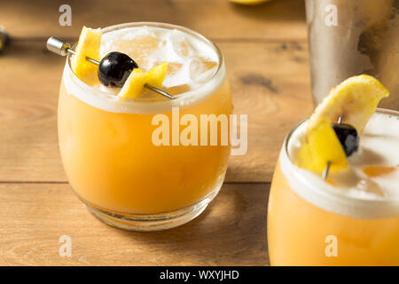 Süße hausgemachte Amarreto Whiskey Sour Cocktail mit einer Kirsche Stockfoto