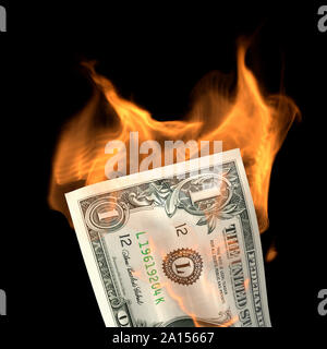 Un billete de dólar billete en fuego Foto de stock