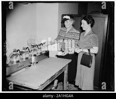 La Sra. Warren R. Austin, esposa del senador de Vermont, muestra la Sra. Wm. Gibbs McAdoo, esposa del senador forma Ca. cómo el café se elabora para el Senado Señoras Almuerzo Club Foto de stock