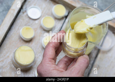 5. Schritt Lippen-und-Pfoten-Salbe selbermachen, selber machen, selber rühren: fertige Salbe wird en Salbendöschen gefüllt. Lippen-und-Pfoten-Balsam, Foto de stock
