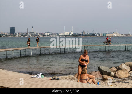 La gente caminando por el puente infinito (Den Uendelige Bro) - muelle de madera con forma de círculo construido sobre un mar de la costa de la Bahía de Aarhus sobre una playa de Varna/Ballehage Playa, creado por el arquitecto Niels Povlsgaard y Johan Gjødes son vistos en Aarhus, Dinamarca, el 30 de julio de 2019 © Michal Fludra / Alamy Live News