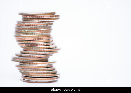 Monedas apiladas sobre fondo blanco trimestres y cambiar Foto de stock
