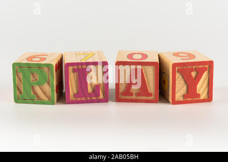 Un niño del juguete del alfabeto ortografía word conjunto de bloques, deletrear la palabra jugar a través de la trama Foto de stock