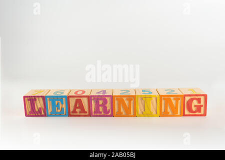 Un niño del juguete del alfabeto ortografía word conjunto de bloques, deletrear la palabra aprendizaje a través de la trama Foto de stock