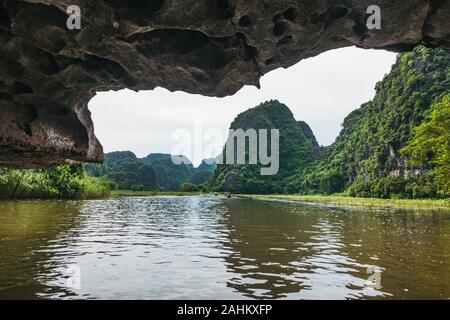 A la deriva en cuevas de piedra caliza en el tour en barco a través de la ONG Río Dong, Tam Coc, provincia de Ninh Binh, Vietnam