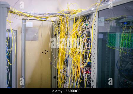 Los cables de Internet desordenados tienen una conexión con los servidores de computadoras. Los armarios con equipo informático están situados en el centro de datos. Los racks con servidores son lo