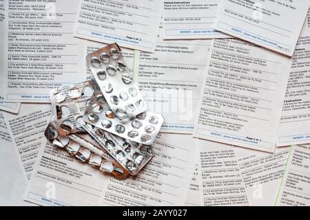 Una selección de solicitudes de receta médica repetitiva emitidas por un médico, con envases vacíos de ampollas para píldoras. Los datos de NB se han anónimo. Foto de stock