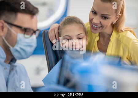 Dentista examinando los dientes de un paciente en dentista office.dentista explicando la imagen de rayos X a paciente.Dientes concepto de salud.Personas,estomatología y salud c Foto de stock