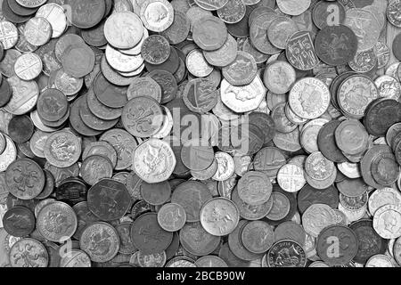 Moneda del Reino Unido, cientos de monedas británicas de cobre y plata apiladas aleatoriamente una encima de la otra, monedas de una libra, cincuenta pence, veinte pence, dos p
