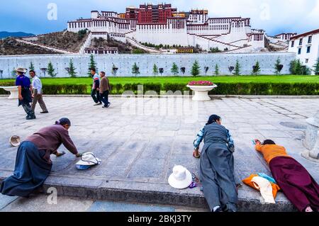 China, Tíbet central, Ü Tsang, Lhasa, Palacio Potala, Patrimonio Mundial registrado por la UNESCO, mujeres en postración Foto de stock