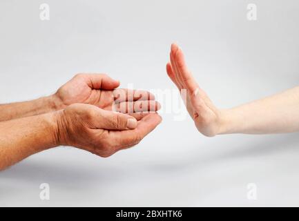 El hombre pide ayuda, la mujer lo rechaza, con el gesto de su mano. Idea de personas necesitadas Foto de stock