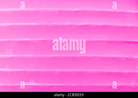 Papel ondulado de color rosa con textura de fondo para decoración Foto de stock