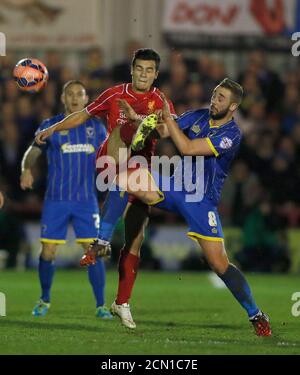 AFC Wimbledon's Sammy Moore (R) challenges Liverpool's Philippe Coutinho during their FA Cup third round soccer match at Kingsmeadow Stadium in Kingston-upon-Thames, southern England January 5, 2015.            REUTERS/Stefan Wermuth (BRITAIN  - Tags: SPORT SOCCER)