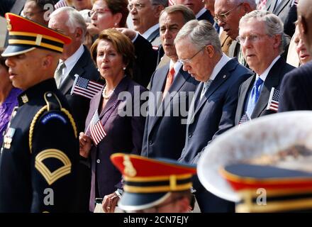 U.S. House Minority Leader Nancy Pelosi (D-CA) (3rd L-R), House Speaker John Boehner (R-OH), Senate Majority Leader Harry Reid (D-NV) and Senate Minority Leader Mitch McConnell (R-KY) stand to sing 'God Bless America' during a remembrance of lives lost in the 9/11 attacks, at the U.S. Capitol in Washington, September 11, 2013. Bagpipes, bells and a reading of the names of the nearly 3,000 people killed when hijacked jetliners crashed into the World Trade Center, the Pentagon and a Pennsylvania field marked the 12th anniversary of the September 11 attacks in 2001. REUTERS/Jonathan Ernst  (UNITE