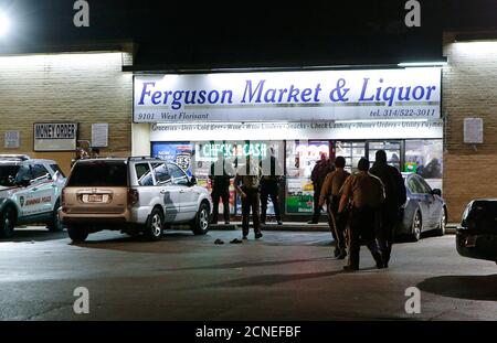 Police line up in front of the Ferguson Market & Liquor during a protest, following a release of previously undisclosed video of Michael Brown, in Ferguson, Missouri, U.S. on March 12, 2017. Picture taken on March 12, 2017.  REUTERS/Lawrence Bryant