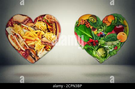 El dilema de la elección de la dieta y el concepto de la salud del corazón. Dos corazones una forma de frutas vegetales verdes y una alternativa hecha de chatarra grasa alta caloría foo Foto de stock