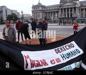 A banner that reads 'To migrate is a human right' is seen during a protest against the Argentine government's decree that changes the immigration law, in front of the Congress in Buenos Aires, Argentina, March 30, 2017. REUTERS/Marcos Brindicci