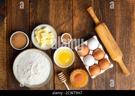 Ingredientes para hornear sobre fondo de mesa de madera. Harina huevos mantequilla especias azúcar y miel, cocinar galletas de pan de jengibre. Horneado de Navidad