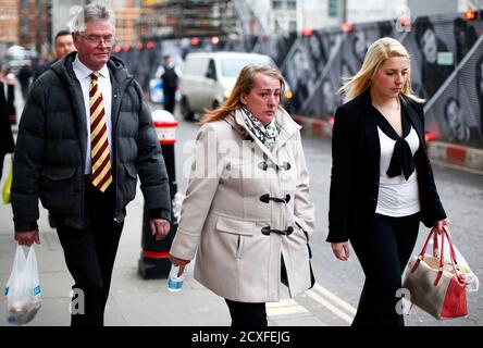 Family members of British soldier Drummer Lee Rigby leave during a lunch break in the trial of his suspected murderers at the Old Bailey in central London December 3, 2013. A police officer who arrived shortly after Rigby was hacked to death in broad daylight on a London street thought she too was going to be killed by one of the suspected murderers, the Old Bailey was told on Tuesday. From L-R: stepfather Ian Rigby, mother Lynn Rigby and Rigby's fiancee Aimee West. REUTERS/Andrew Winning (BRITAIN - Tags: CRIME LAW)