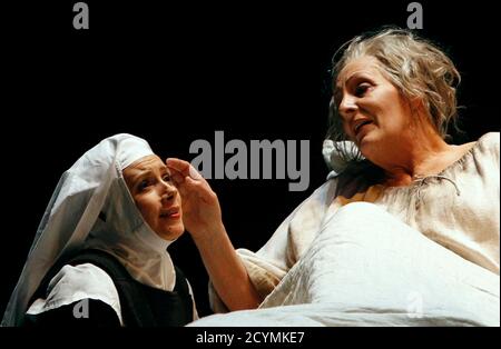 Singers Deborah Polaski (R) and Patricia Petibon perform on stage during a dress rehearsal of Francis Poulenc's opera 'Dialogues des Carmelites' at Theater an der Wien in Vienna April 13, 2011. The opera is conducted by Bertrand de Billy and will premiere on April 16.   REUTERS/Herwig Prammer (AUSTRIA - Tags: ENTERTAINMENT)