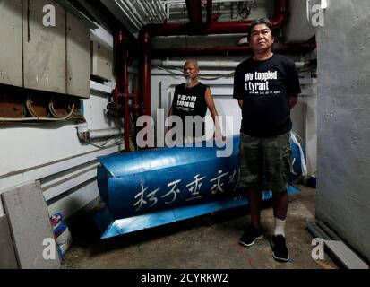Lawmaker Leung Kwok-hung (R), 58, and worker Koo Sze-yiu, 67, pose with a mock coffin inside a factory building, where Koo made the coffin, in Hong Kong May 31, 2014. The two are some of the most prominent protesters in the territory, due to their radical gestures in demanding the redress of the mililtary crackdown on the pro-democracy movement at Beijing's Tiananmen Square in 1989. Recalling his memories of the time, Koo said, 'I was very angry and thought the regime had no future.' Leung said, 'If another pro-democracy movement occurs on the mainland and we protest, I guess we will face the 
